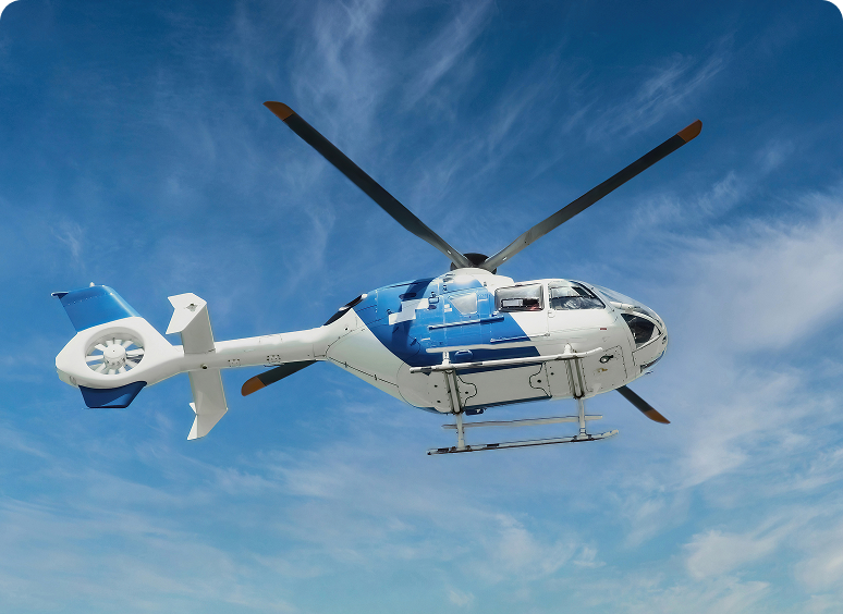Blue and white helicopter flying